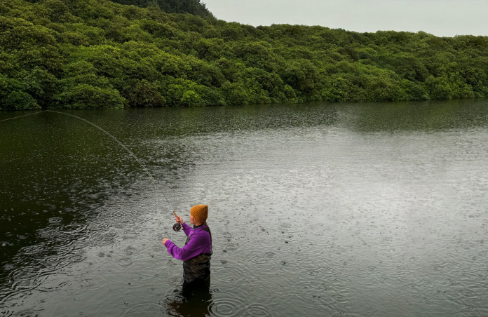 Photo of a woman fly-fishing in a stream, Pixelmator Pro tool removing unwanted objects